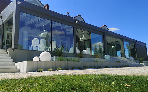 Modern home with floor to ceiling glass windows.